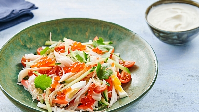 Salad with caviar, crab sticks, cucumbers and tomatoes