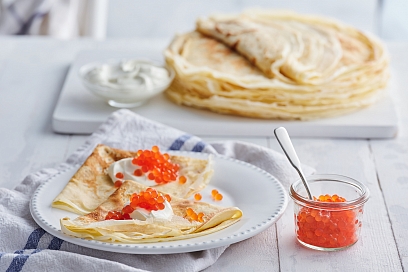 Openwork pancakes with sour cream and caviar